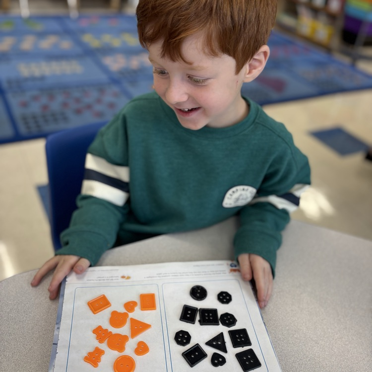 boy sorting buttons