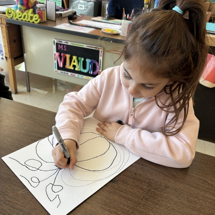student drawing pumpkin