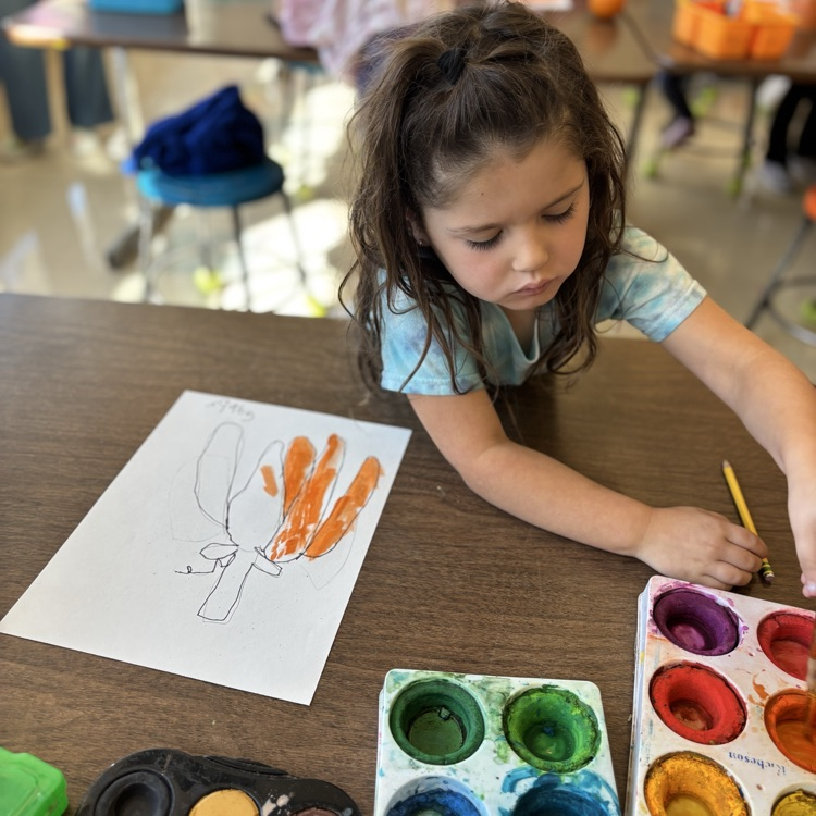 student painting, pumpkin
