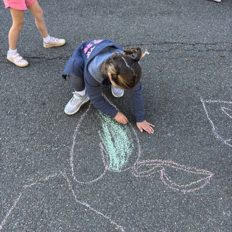 girl drawing a heart