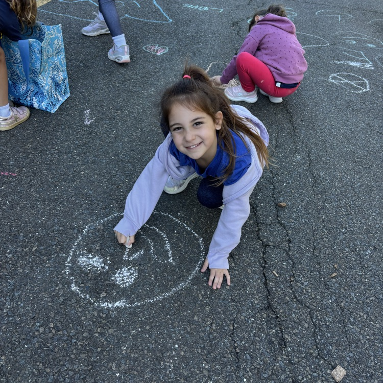 girl making a happy face with chalk
