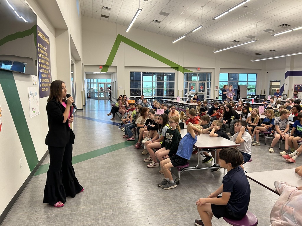 A speaker addresses a group of attentive students in the Wylie East Elementary cafeteria.