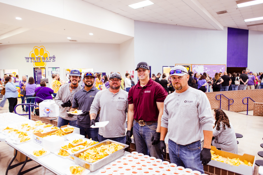 men serving chips and salsa