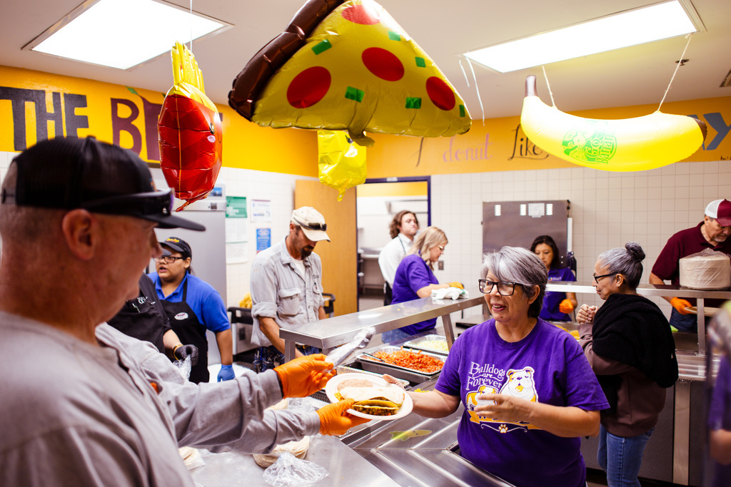 teacher getting served food in lunch line