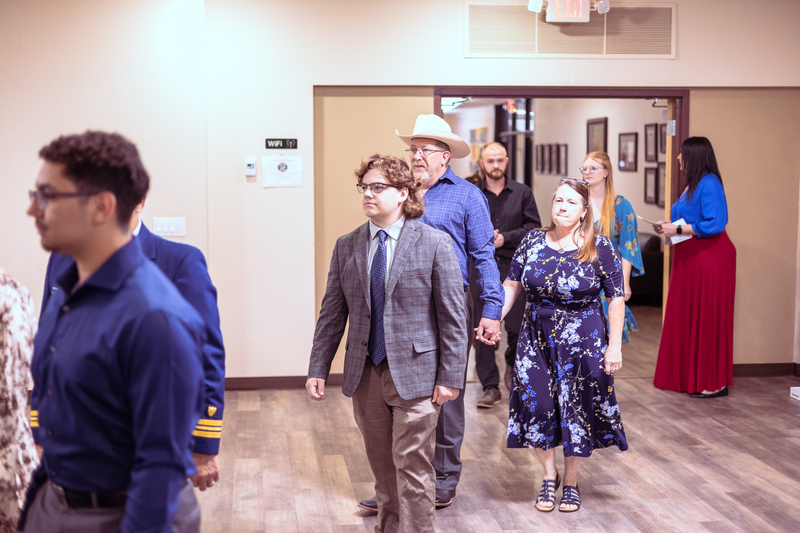 Students walking into the room together, dressed up for Military Signing Day.