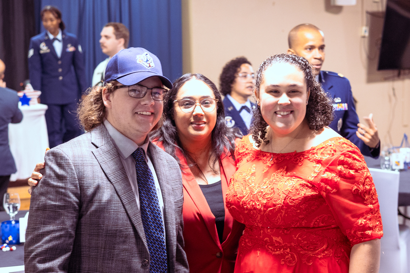Student smiling with family members during Military Signing Day celebration.