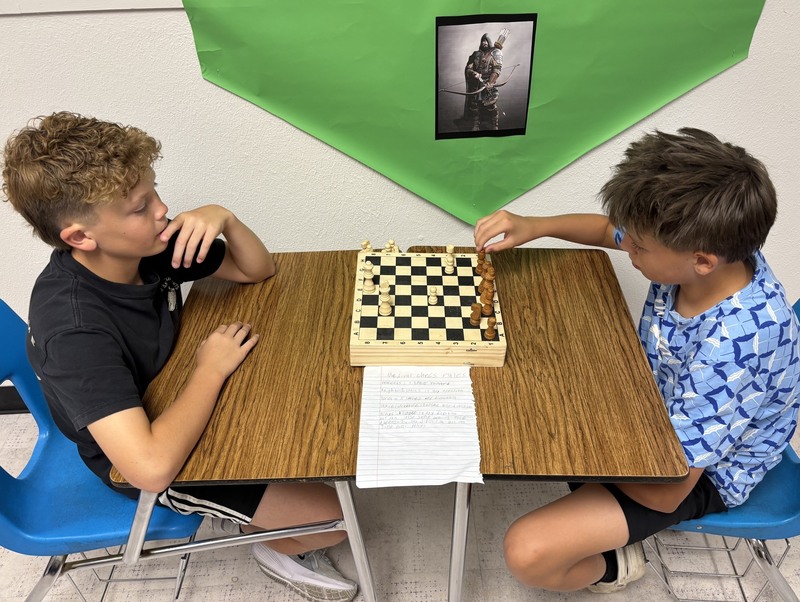 Jett Choate, left, and Miles LaFevre plays chess, a favorite game of medieval times.