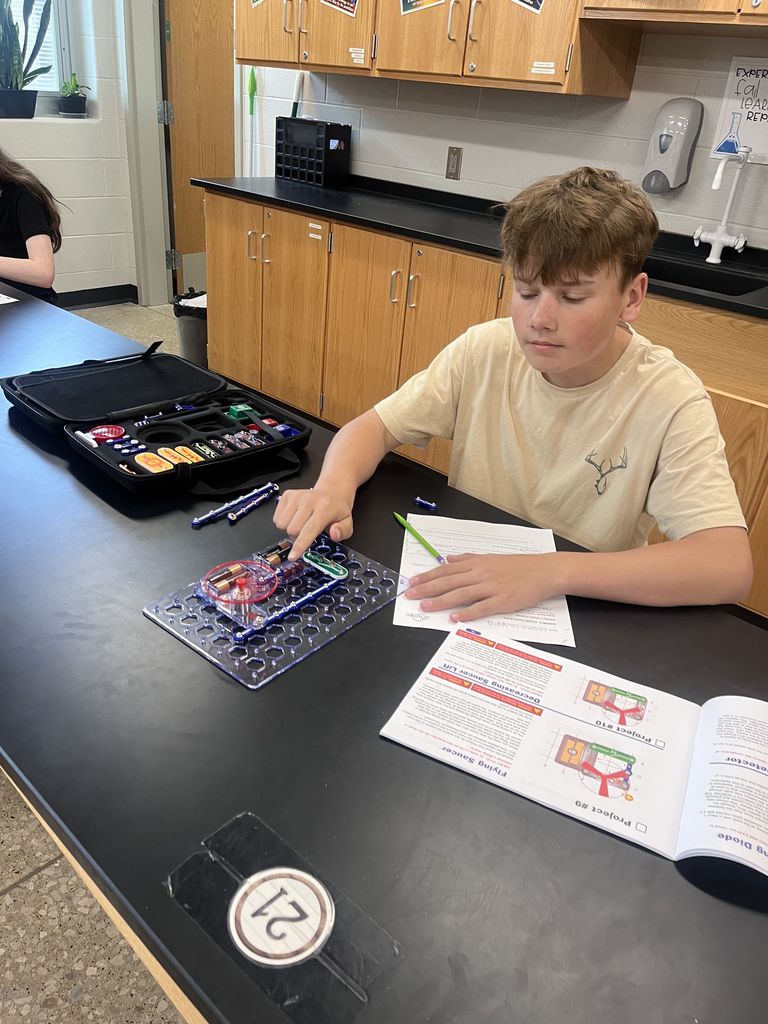 Physical science students build circuits.
