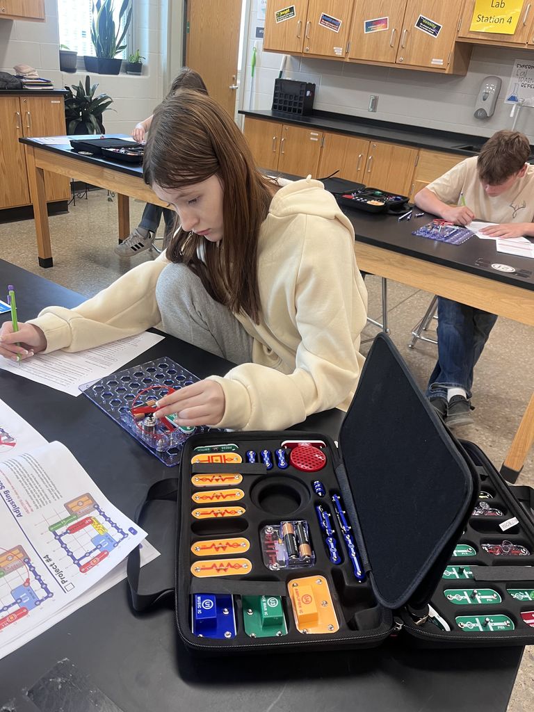 Physical science students build circuits.