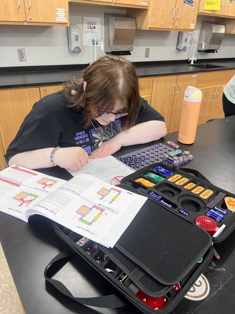 Physical science students build circuits.
