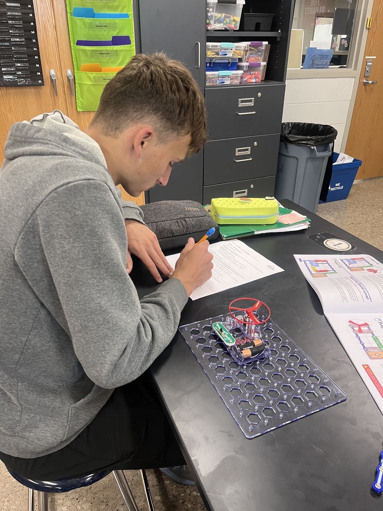 Physical science students build circuits.