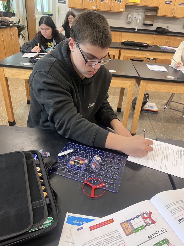 Physical science students build circuits.