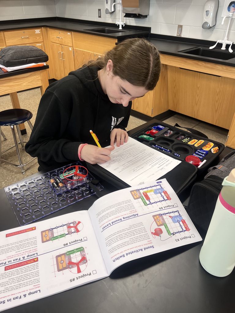 Physical science students build circuits.