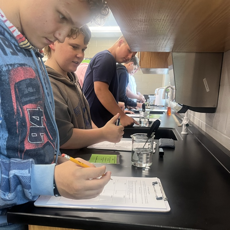 Physical science students perform their first lab of the year.