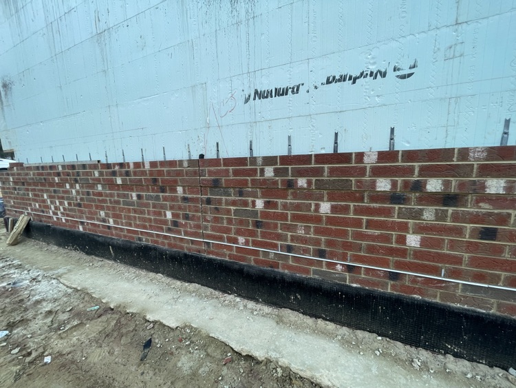 Photos of brick being laid