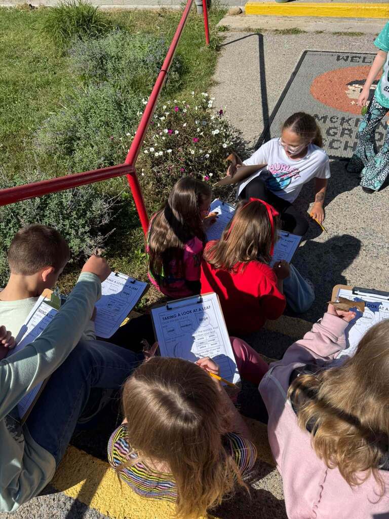 Students record their observastions on the front steps.
