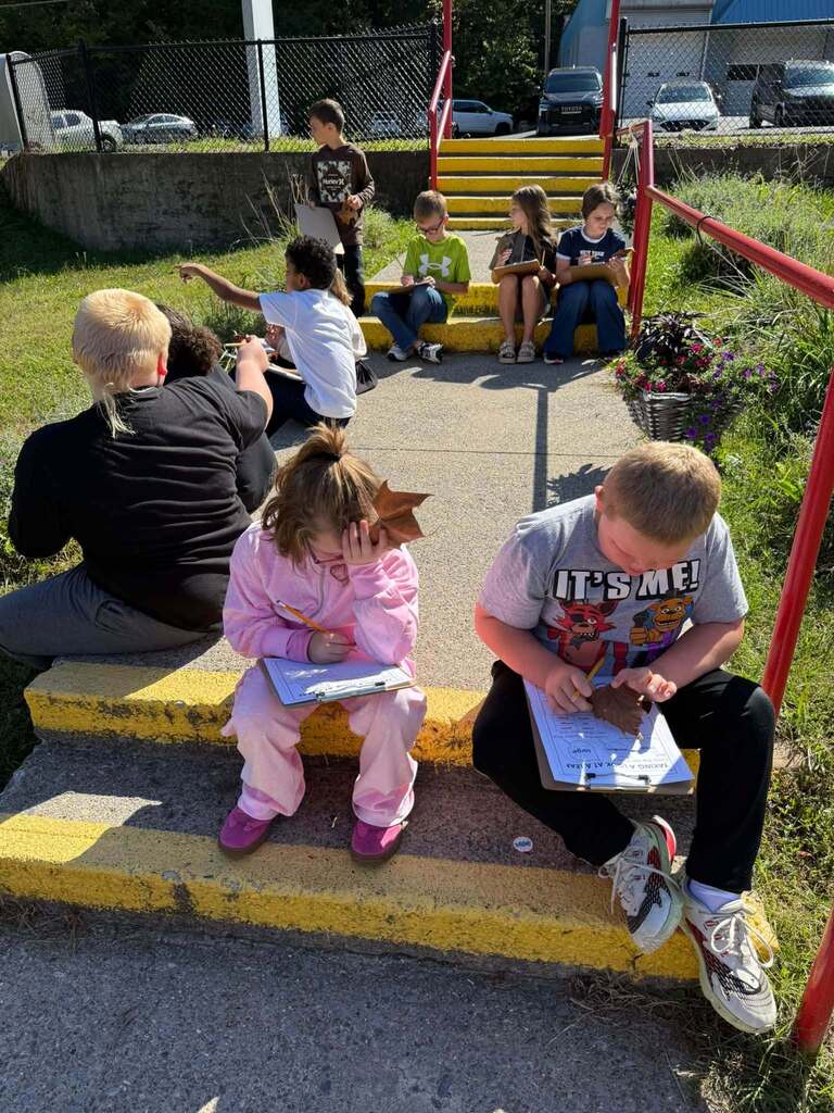 Students record their observastions on the front steps.
