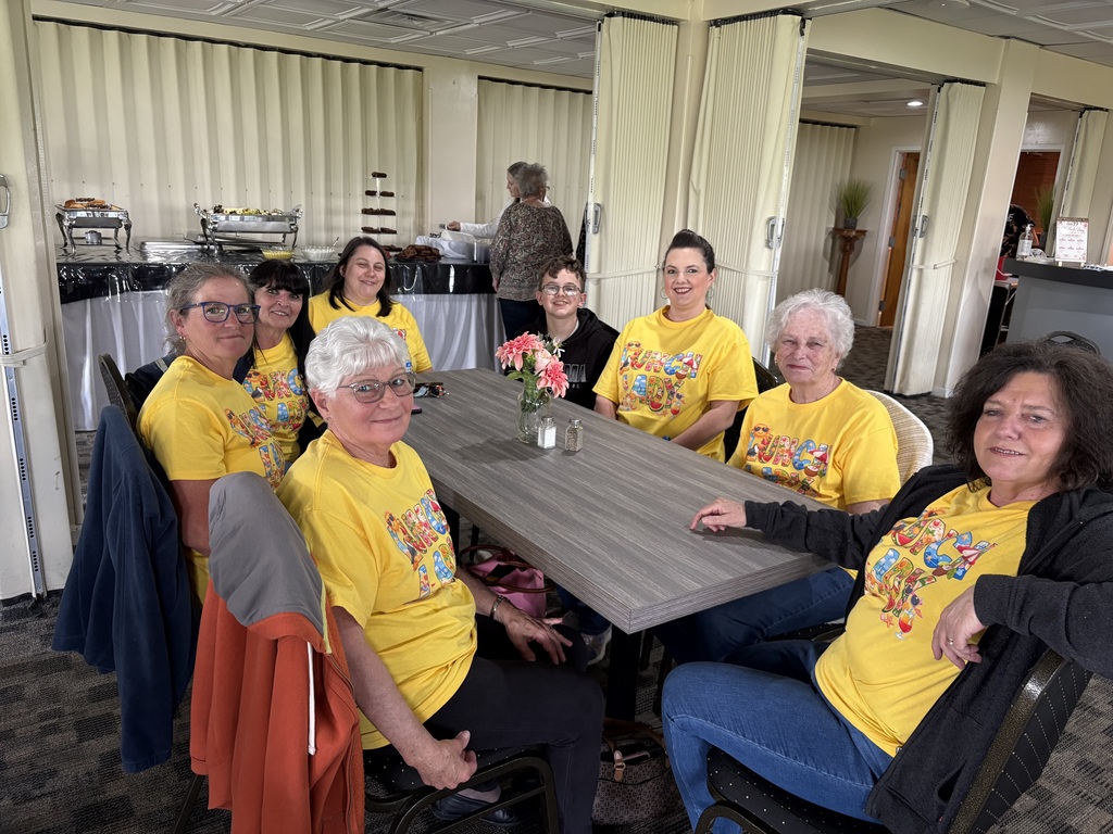 Eight people sitting at a shared table.