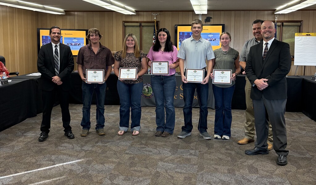 Dr. Street, Mr. Alexander, and Principal Mr. Blankenship awarding 5 FFA State Champions at the School Board Meeting.