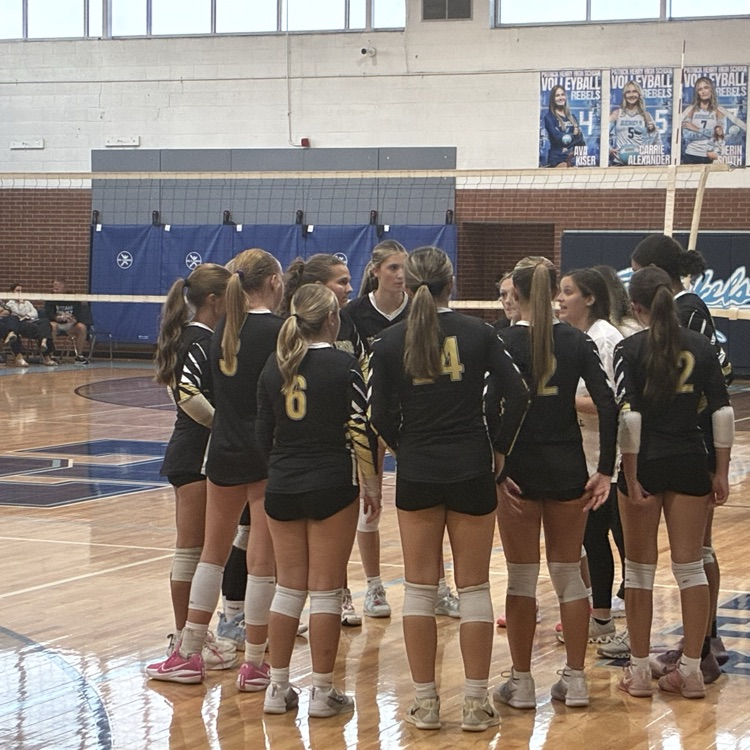 Volleyball team gathers during a time out