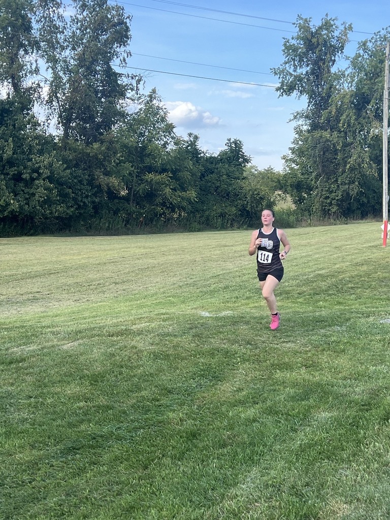Female cross country runner pushes to the end of the race.