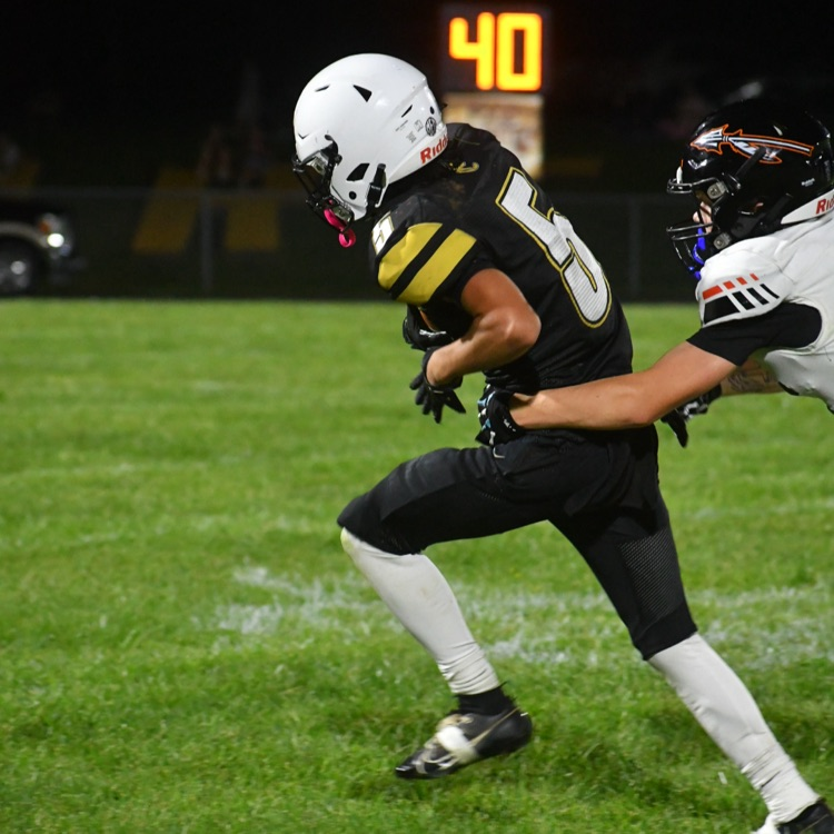 Football player #5 runs the ball.