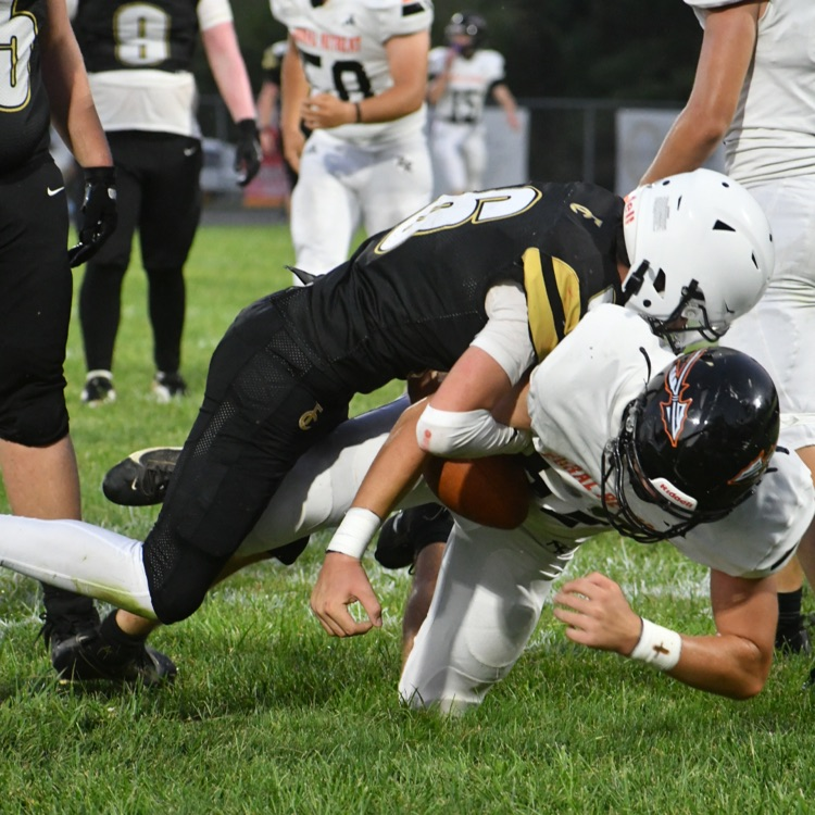 Football player #6 gets a tackle