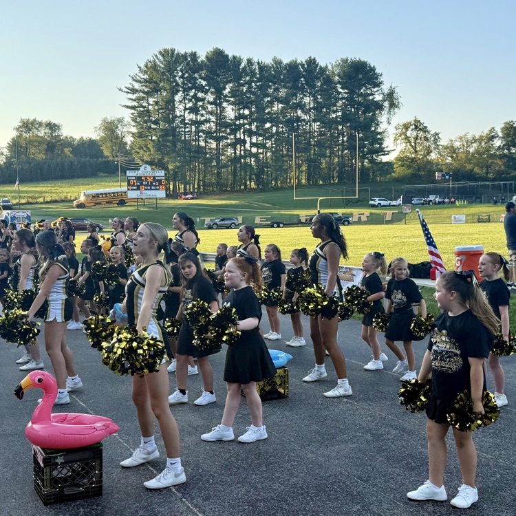 Elementary and high school cheerleaders cheer together for the Pioneer team!