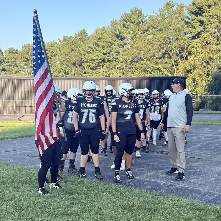 The coach stands with the team before running out