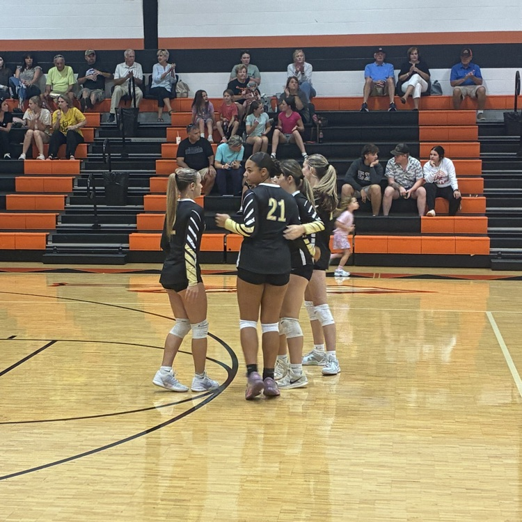 The girls circle up after a play before resetting to get the next point.