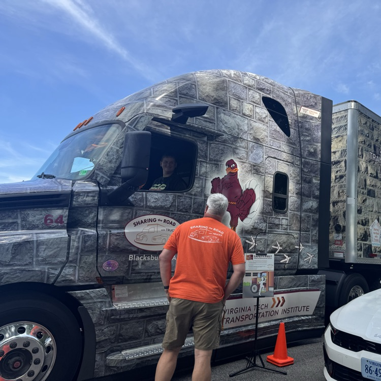 Student sits in the driver’s seat of the truck as the instructor gives directions.