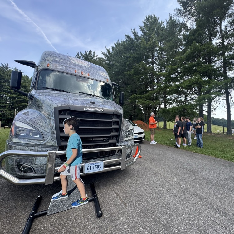 A pretend pedestrian crosses the road in front of the driving instructor’s truck.