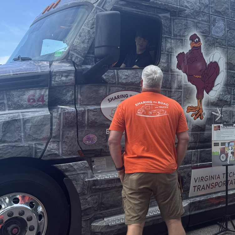 Student sits in the driver’s seat of the truck as the instructor gives directions.