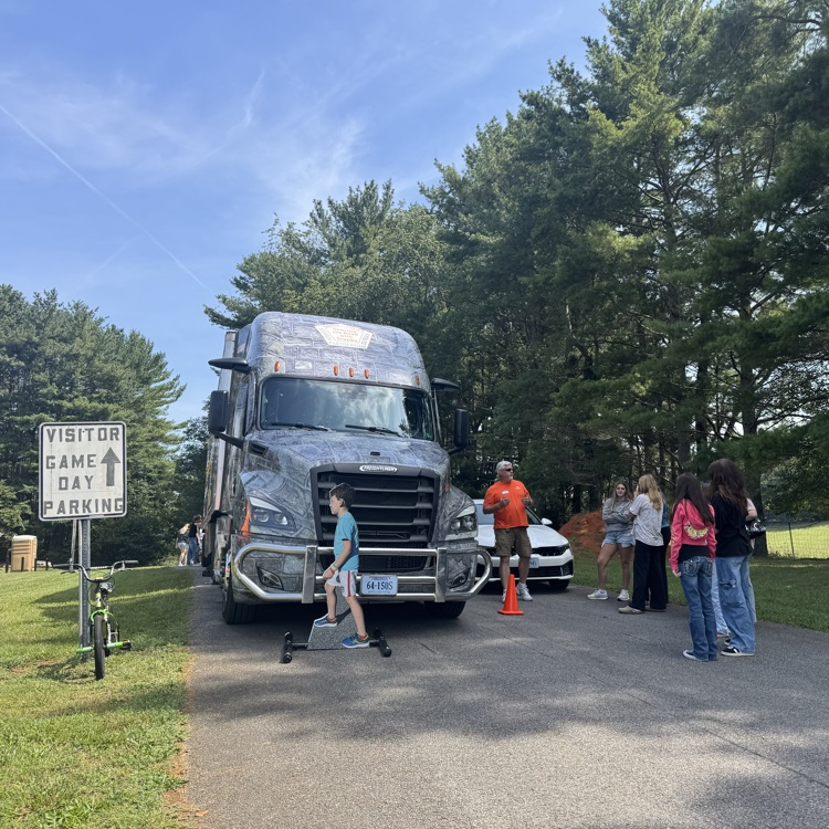 The pretend pedestrian is in front of the instructor’s truck as the students watch what to do.