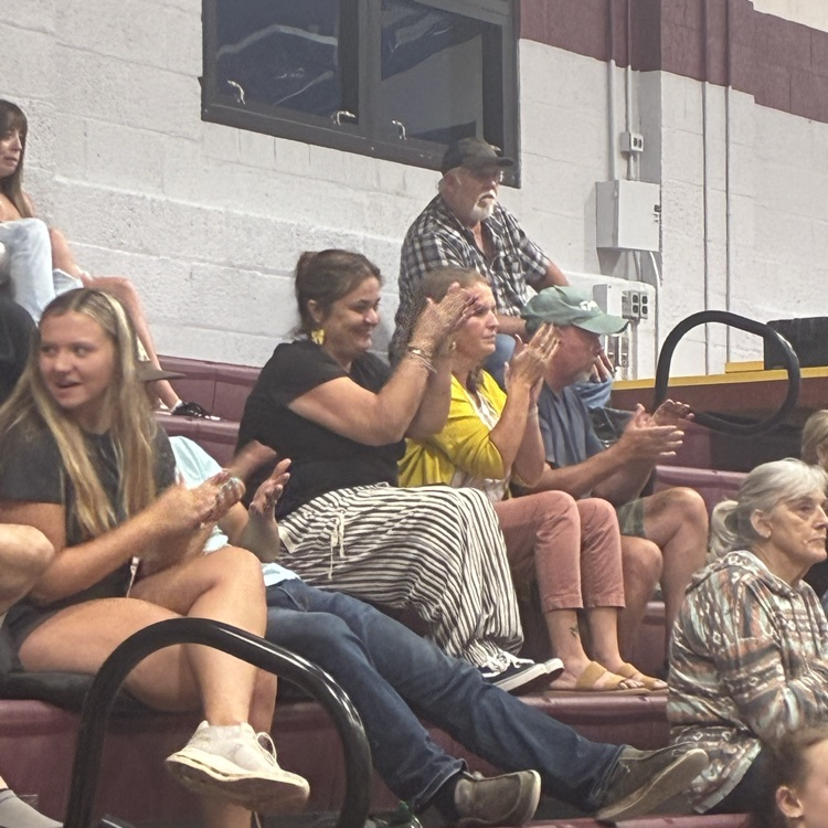 fans and pioneer principal cheer on the team