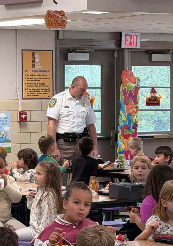 Sheriff Cline with students in lunch room.