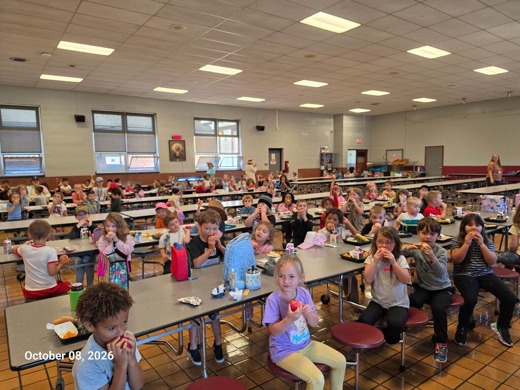 Students biting their apples.