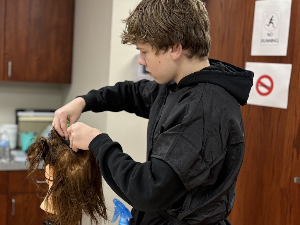 Student cutting hair