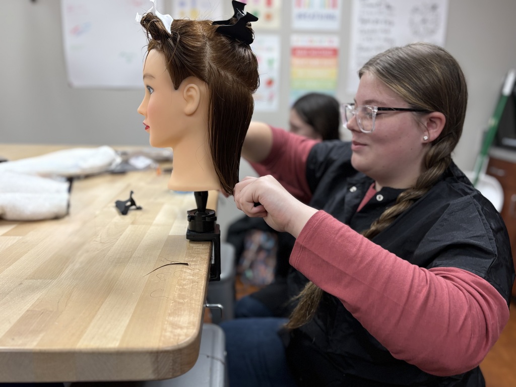 student cutting hair