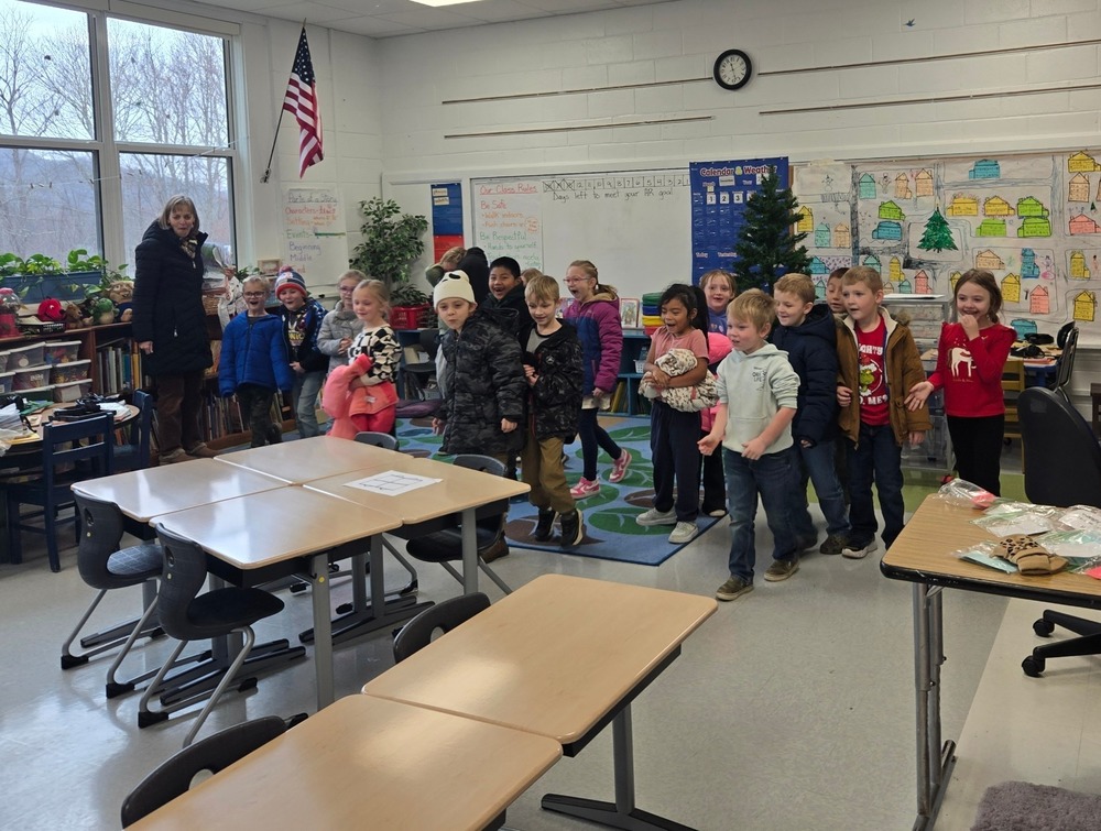 children walking into a classroom to look at new desks