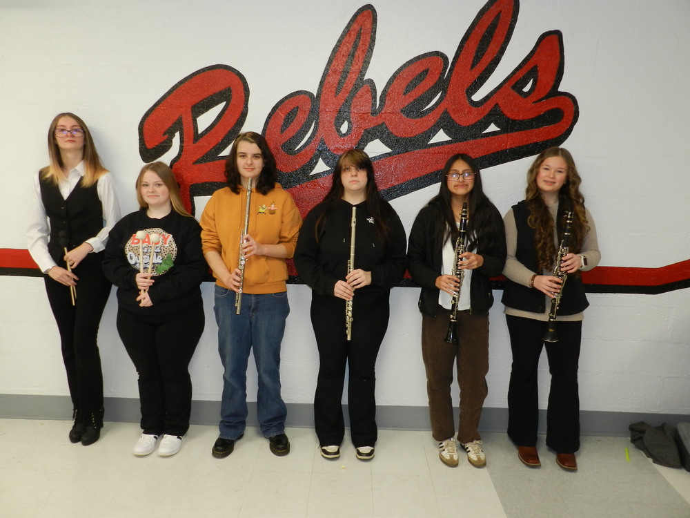 two girls holding mallets, two girls holding flute and two girls holding clarinets