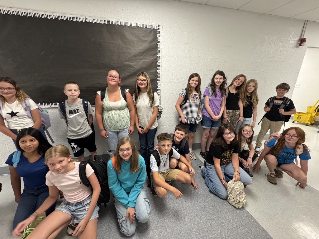 middle school boys and girls posing for a picture in two lines