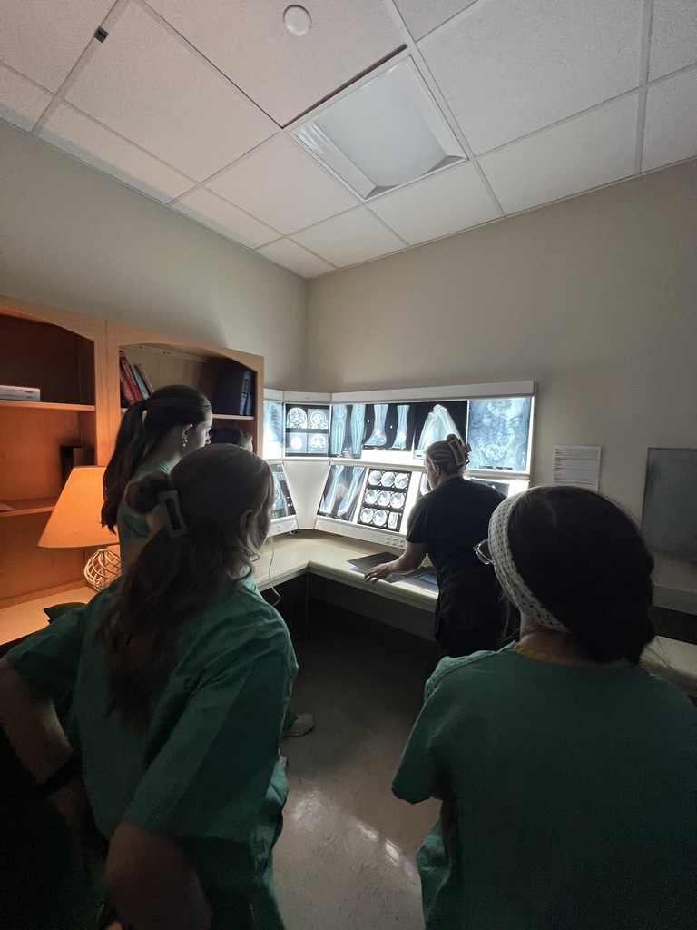 three students and one instructor looking at x ray images