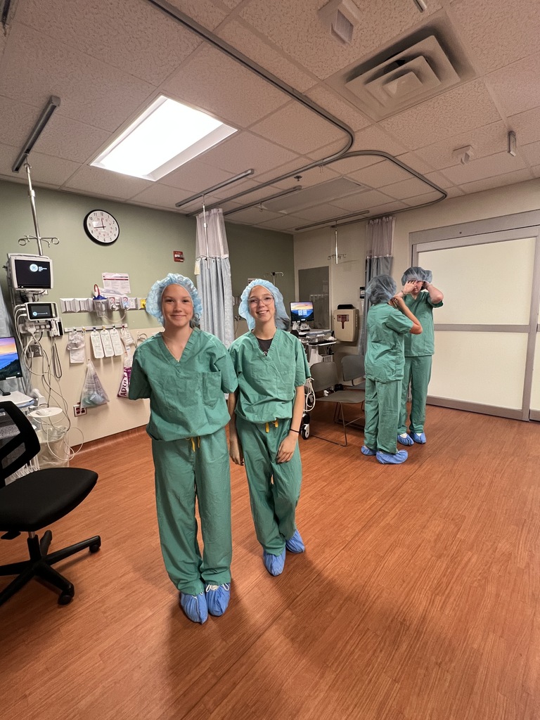 two female students in scrubs smiling