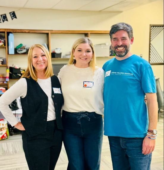 two women and one man smiling