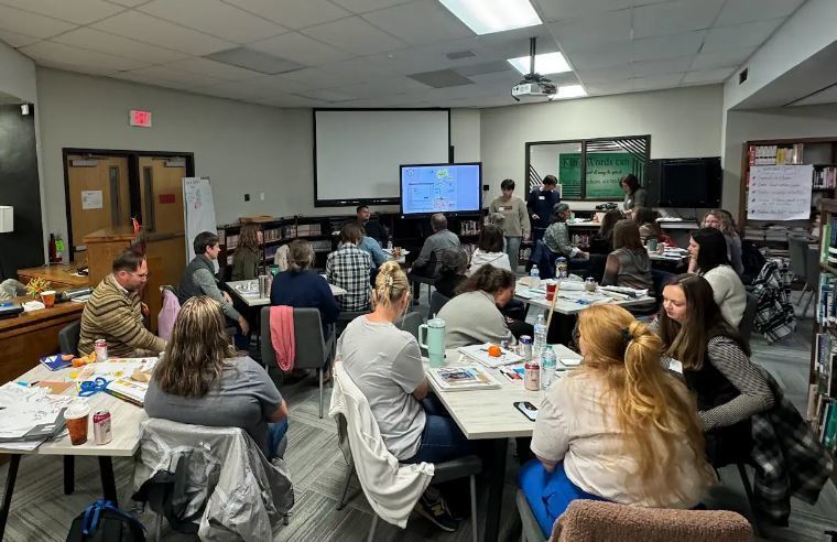 group of adults in a school library