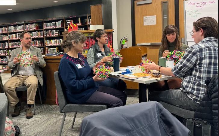 adults in a library using sensory toys