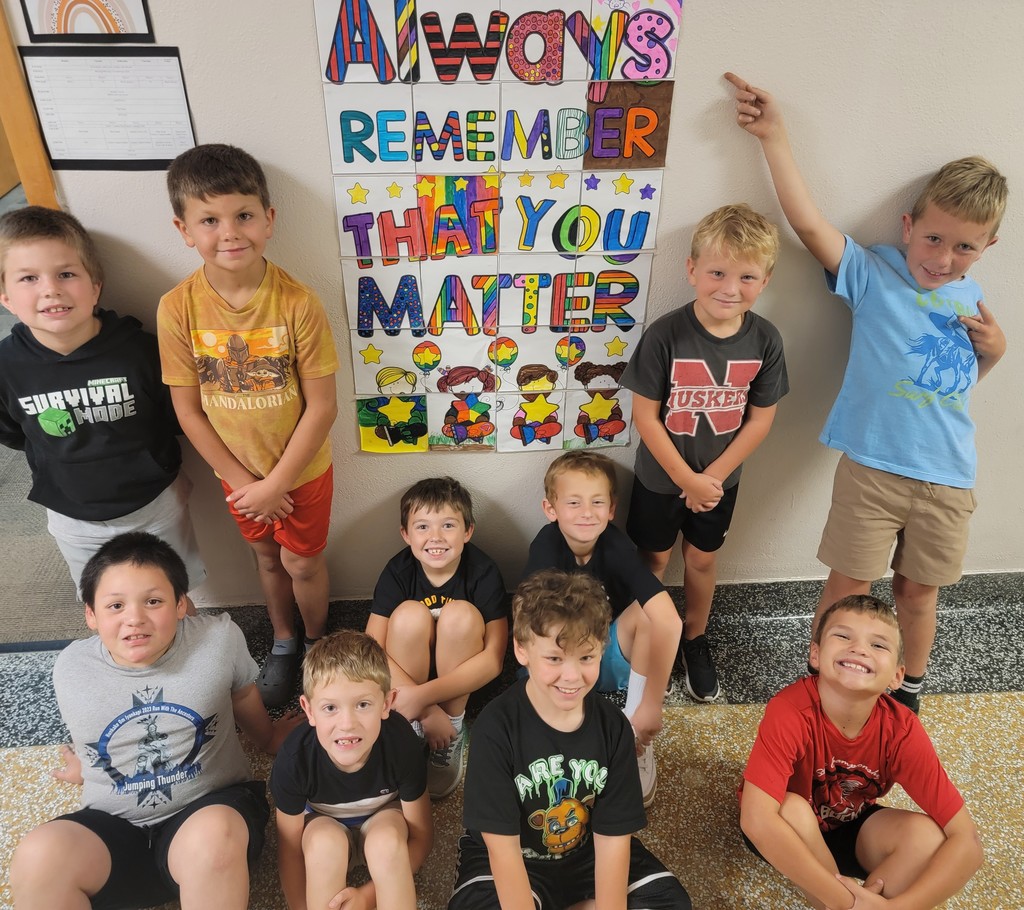 students posing by art