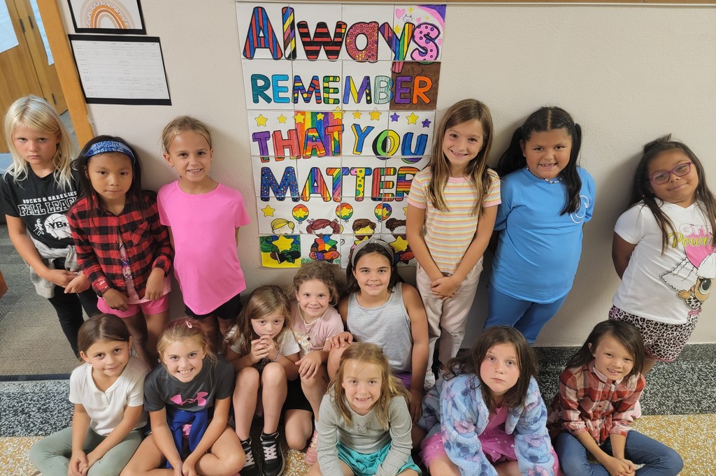 students posing by art