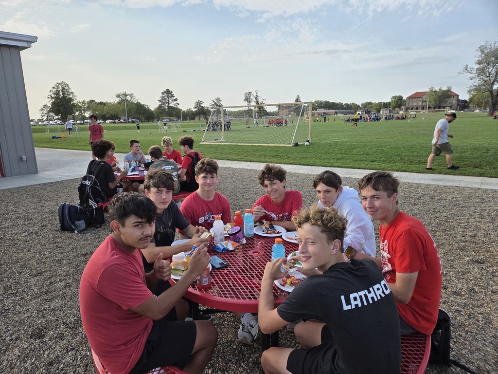 Boys enjoying sandwiches and ice-cream.